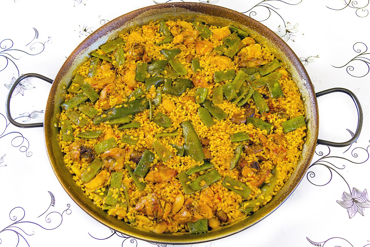 Traditional Valencian paella cooked over wood fire — Valencia, Spain